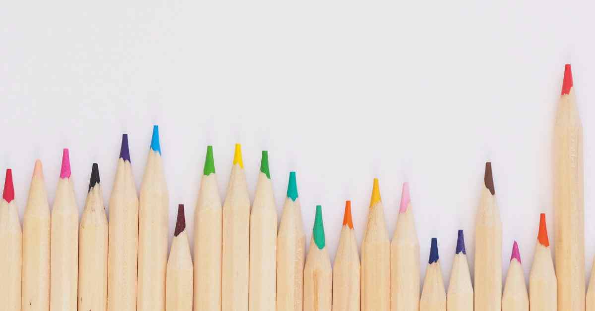 Multi colored colored pencils in a row and various heights